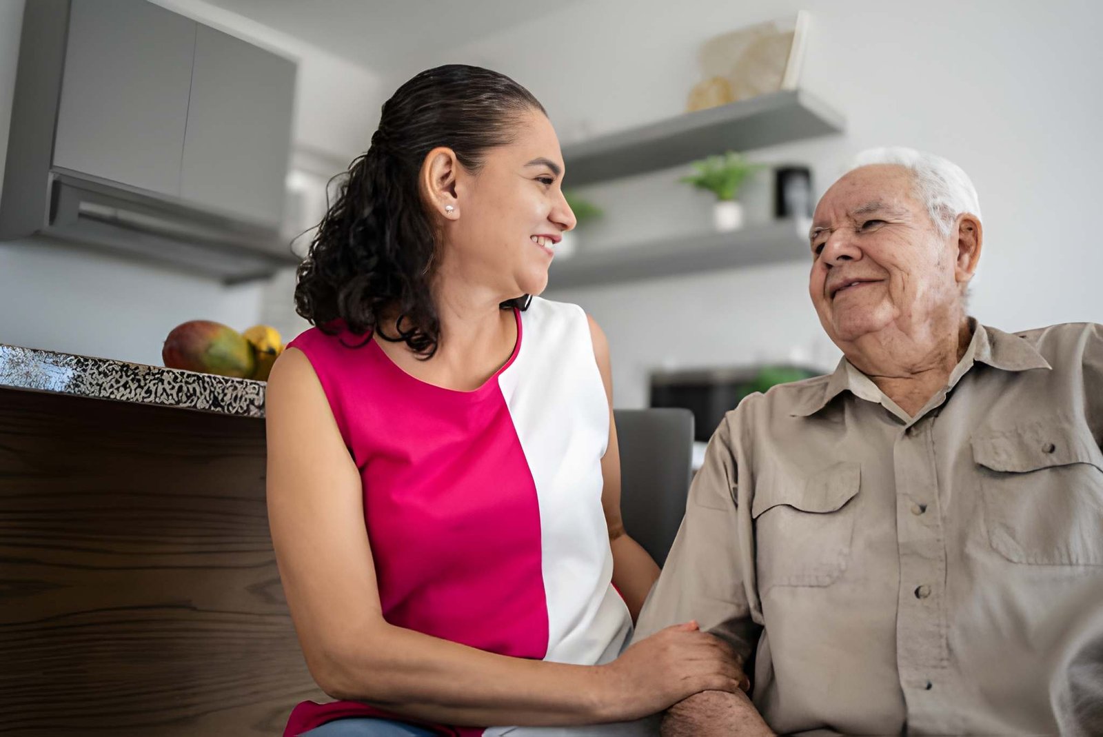 Caregiver holding patient's hand